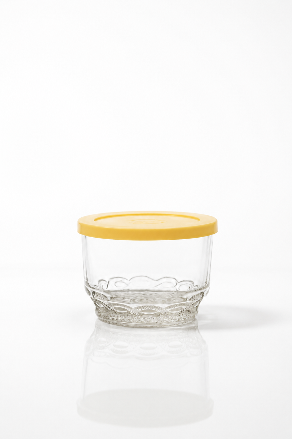 Lace-embossed glass prep bowl with yellow silicone lid